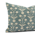 Close up of Tonic Living Hazel Pool pillow showing its muted blue-green and beige floral pattern with leafy stems and blooms.