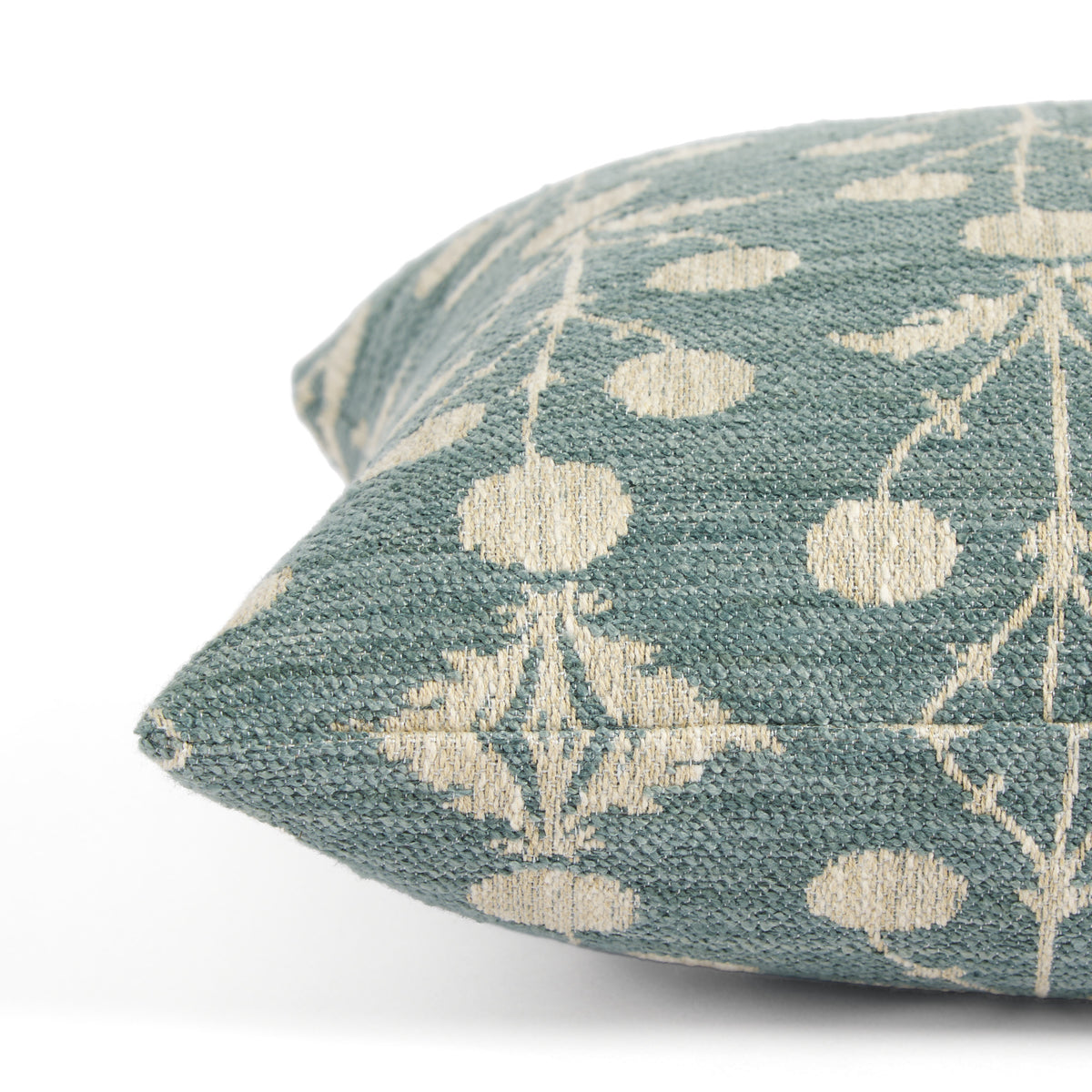 Side view of Tonic Living Hazel Pool decorative cushion highlighting its blue-green and beige floral pattern.