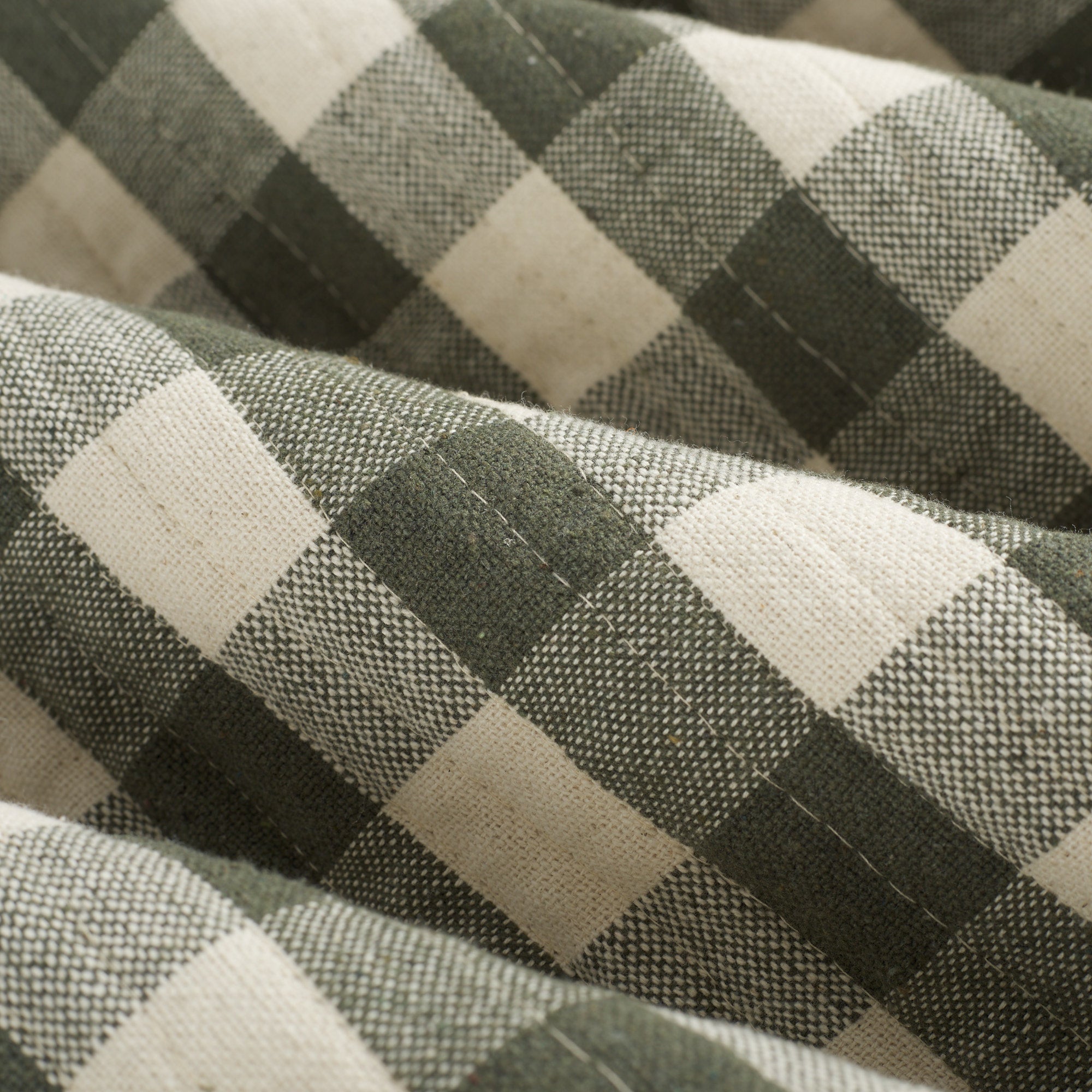 Close up of Tonic Living Henry Check Forest Green fabric showing quilted texture and gingham check detail.