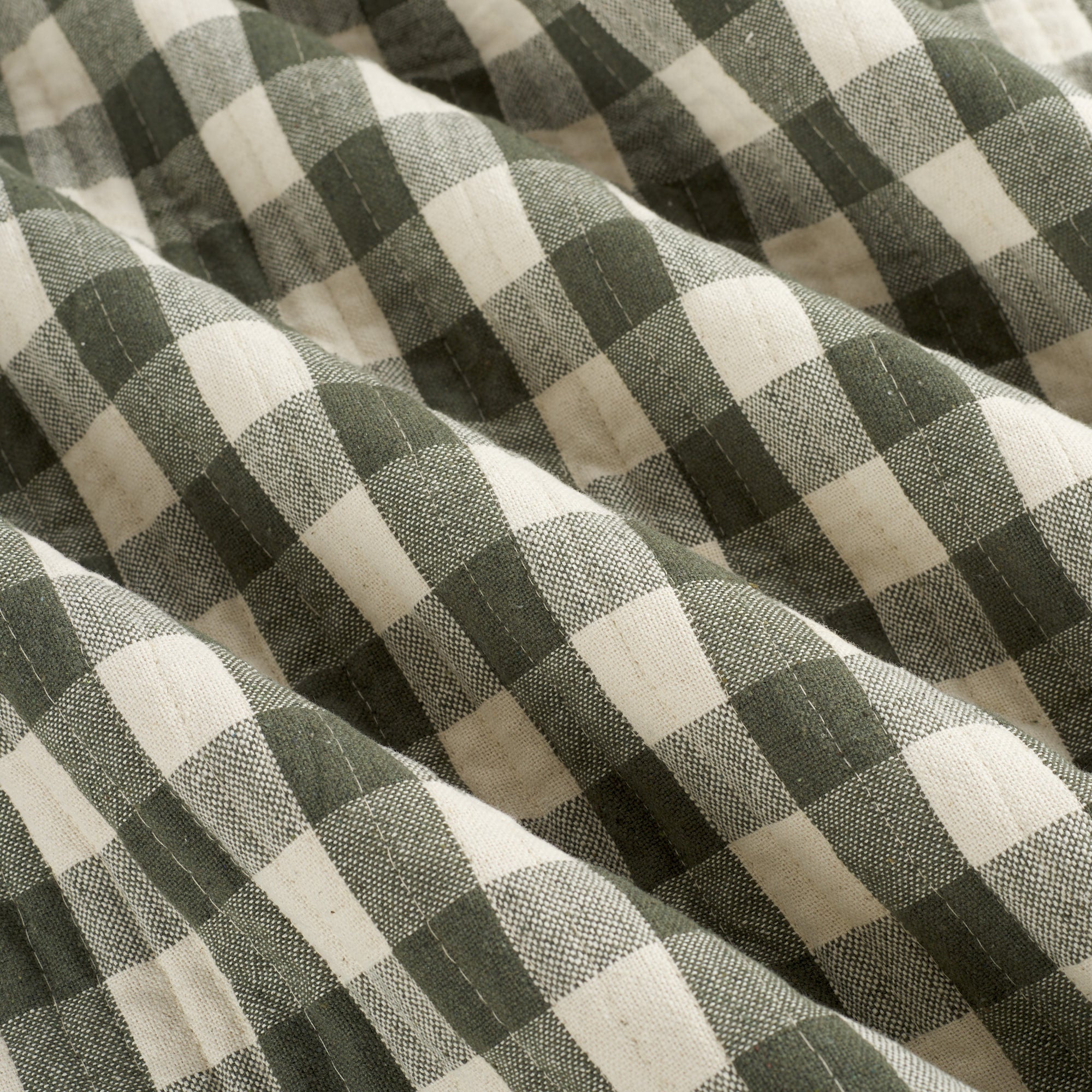Tonic Living Henry Check Forest Green quilted fabric featuring a dark green and natural gingham check.