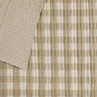 Tonic Living Henry Check Fabric in Wheat, a quilted matelassé fabric with off-white and beige gingham check and coordinating stripe reverse.