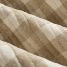 Close up of Tonic Living Henry Check Wheat fabric showing quilted texture and off-white and beige gingham detail.