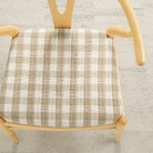 Tonic Living Henry Check Wheat upholstery fabric shown on a chair seat with classic off-white and beige gingham pattern.