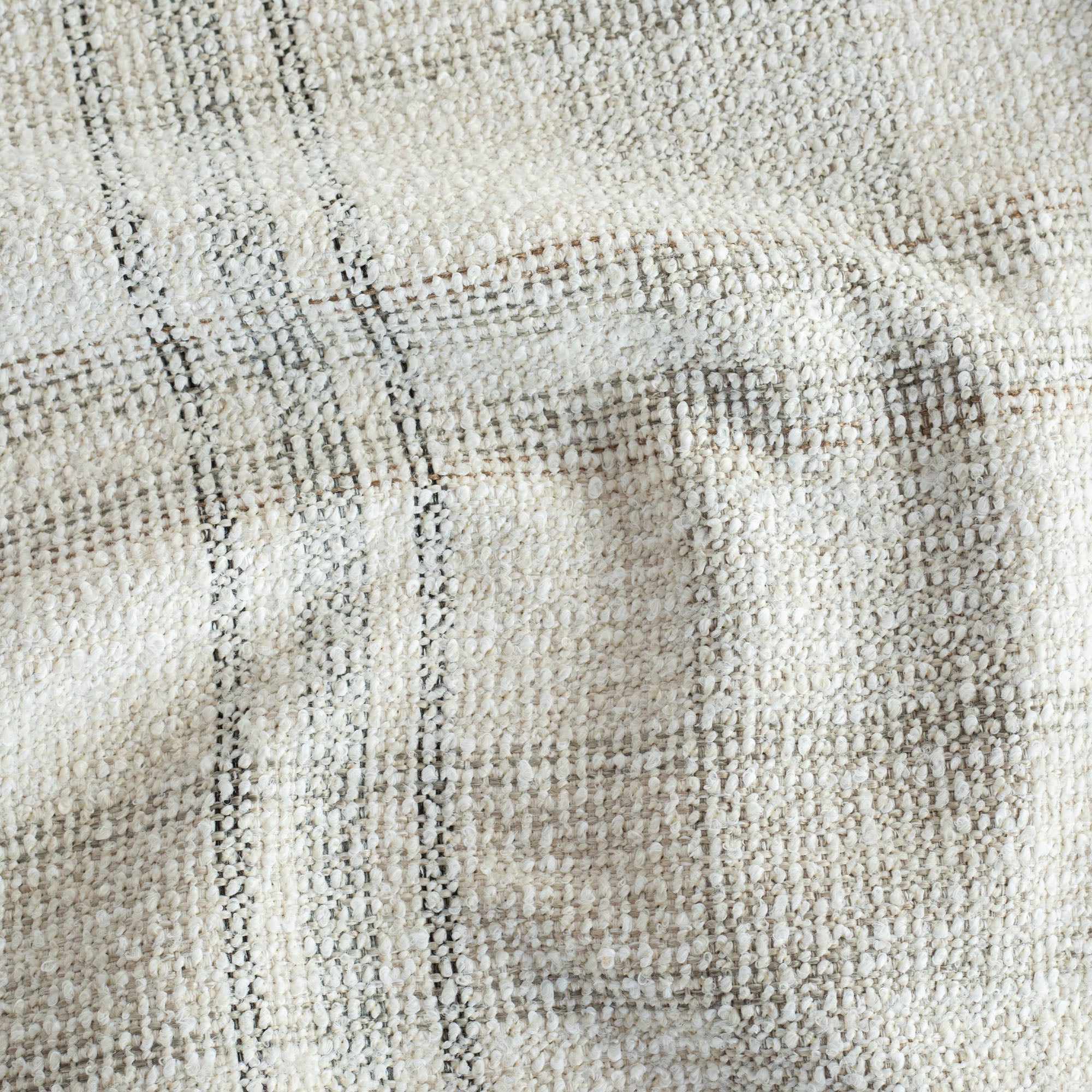 a cream, brown and grey high performance plaid patterned upholstery fabric: close up view