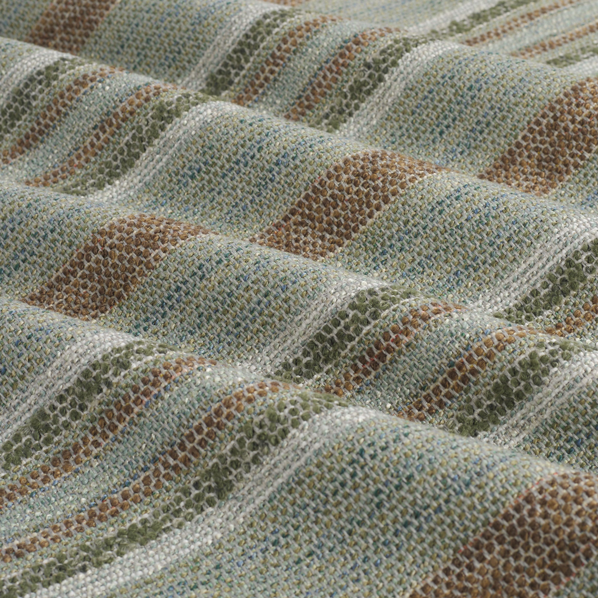 Close up of Tonic Living Indie Lagoon high-performance fabric showing textured green-teal stripes with movement.