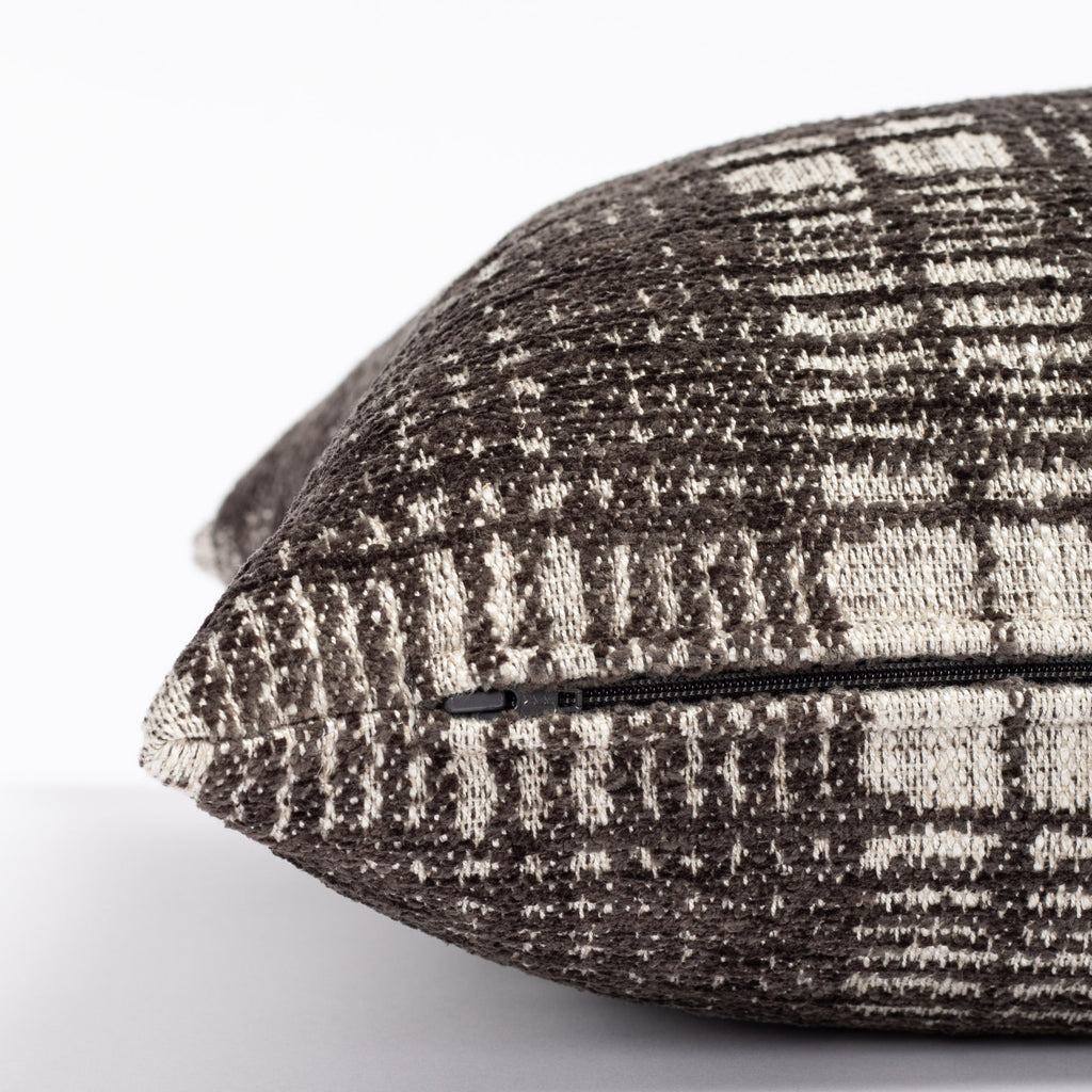 a charcoal grey and beige chenille textured plaid throw pillow : close up zipper view