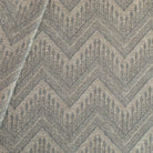 Joyce Fabric denim, a warm grey upholstery fabric with a delicate woven blue geometric zig zag pattern from Tonic Living
