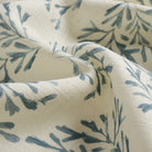 Close up of Tonic Living Juniper Harbour Blue fabric showing blue and cream botanical sprig detail.