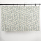 Full yard of Tonic Living Juniper Harbour Blue curtain fabric showing blue botanical print on cream ground.