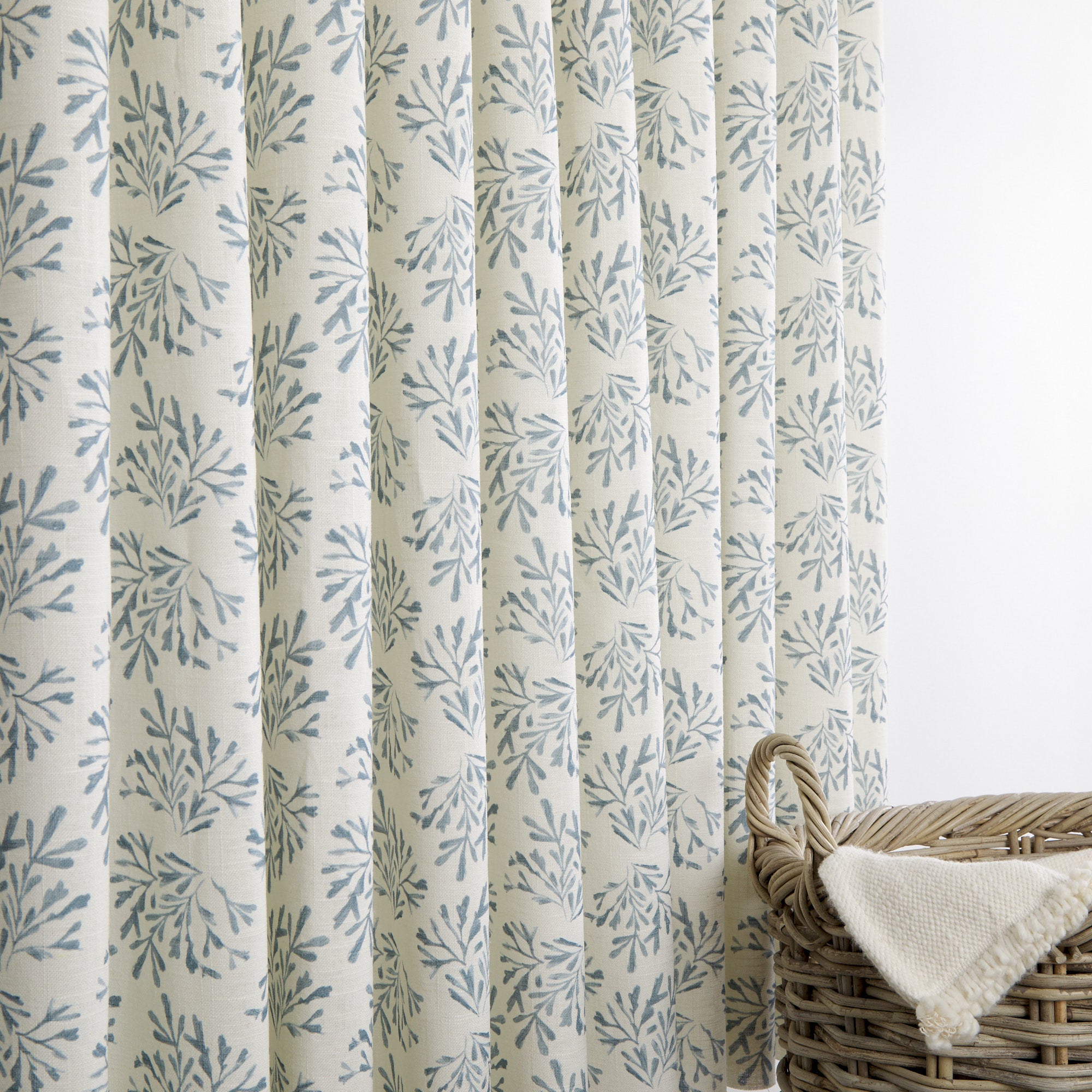 Tonic Living Juniper Harbour Blue drapery fabric with botanical print shown as blue and cream curtains.
