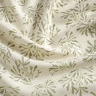 Tonic Living Juniper Sage fabric featuring a sage green and white botanical sprig print.