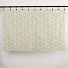 Full yard of Tonic Living Juniper Sage curtain fabric showing sage green botanical print on cream ground.
