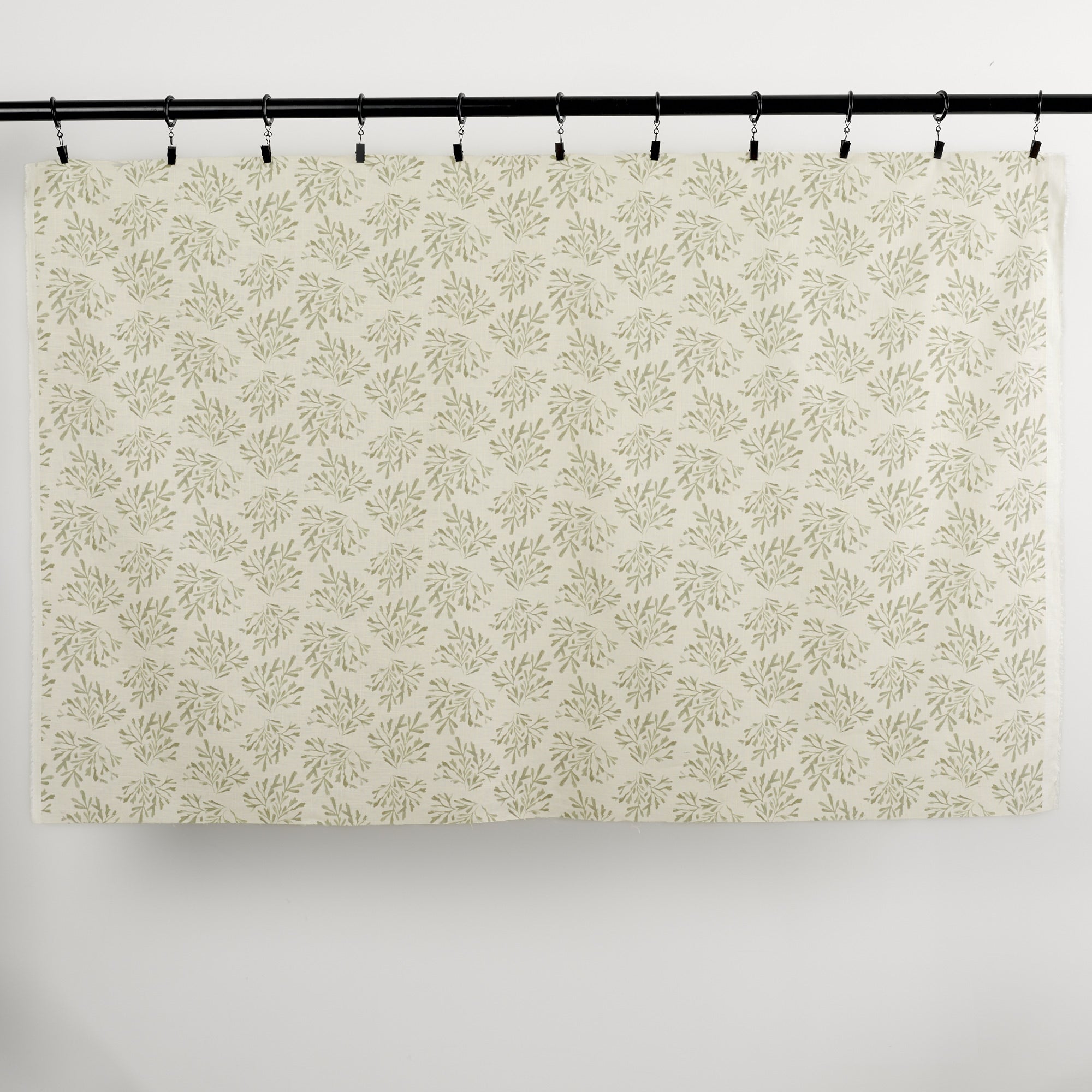 Full yard of Tonic Living Juniper Sage curtain fabric showing sage green botanical print on cream ground.