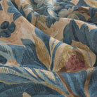 Close-up of Juno Fabric, Navy by Tonic Living — detailed botanical floral print in navy blue and warm earthy tones.