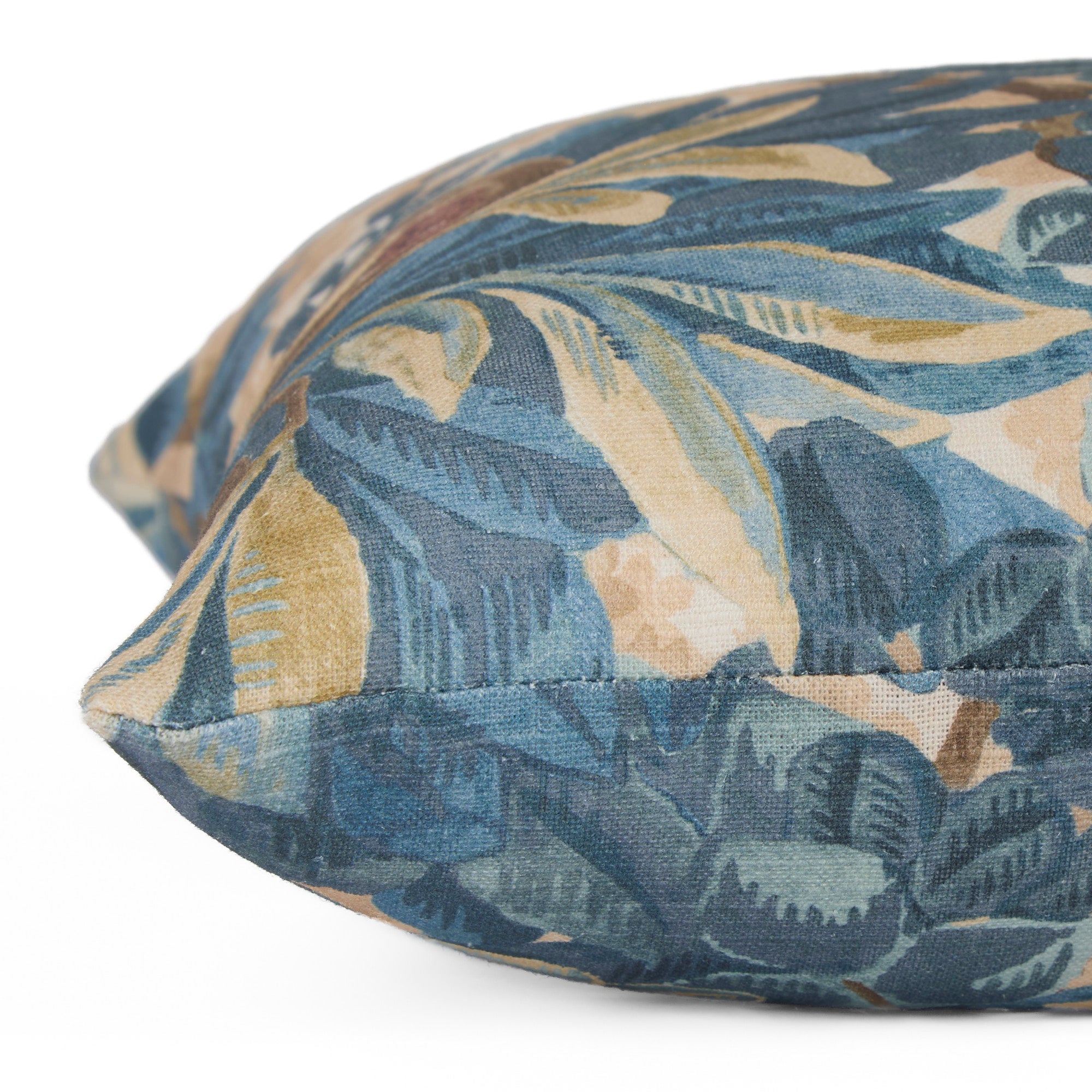 Close-up side view of Juno Navy decorative pillow by Tonic Living — detailed botanical floral pattern on linen-blend fabric.