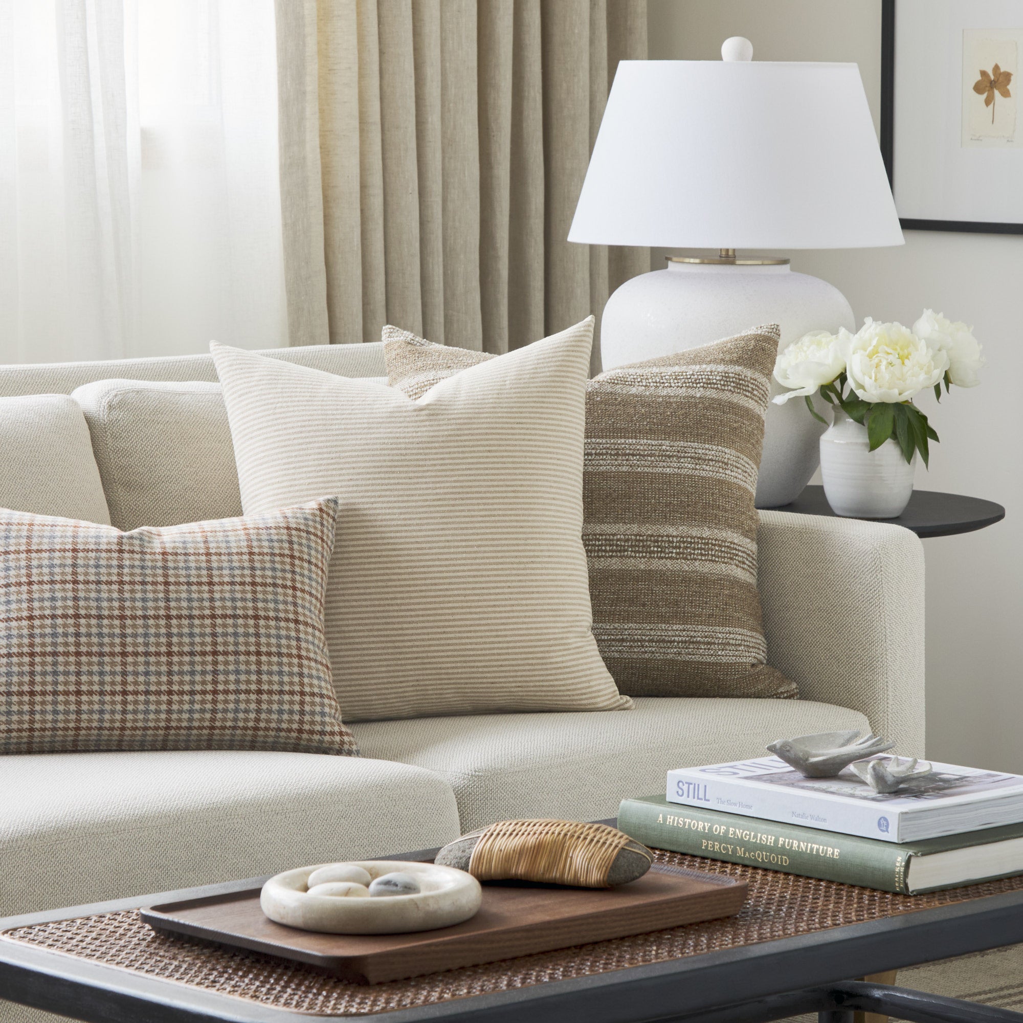 Tonic Living Leo Stripe Wheat decorative pillow styled on a sofa with neutral textured cushions.