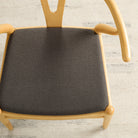 Dining seat upholstered in Loden Fabric, Mink by Tonic Living — durable high-performance upholstery fabric in a soft brown-grey tone.