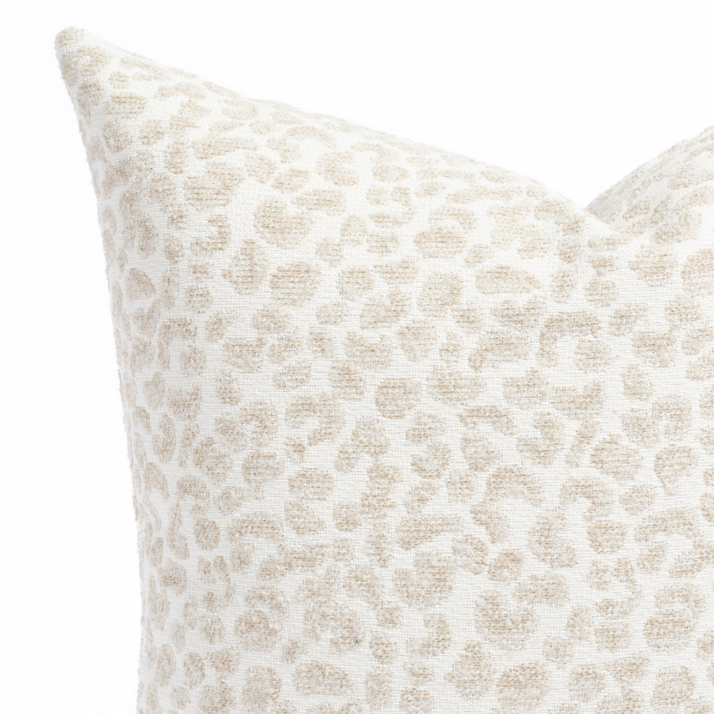 a creamy white and taupe beige speckled cheetah patterned indoor outdoor pillow : close up view