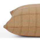 Side view of Tonic Living Lundie Plaid decorative pillow highlighting its herringbone texture and warm camel tones.