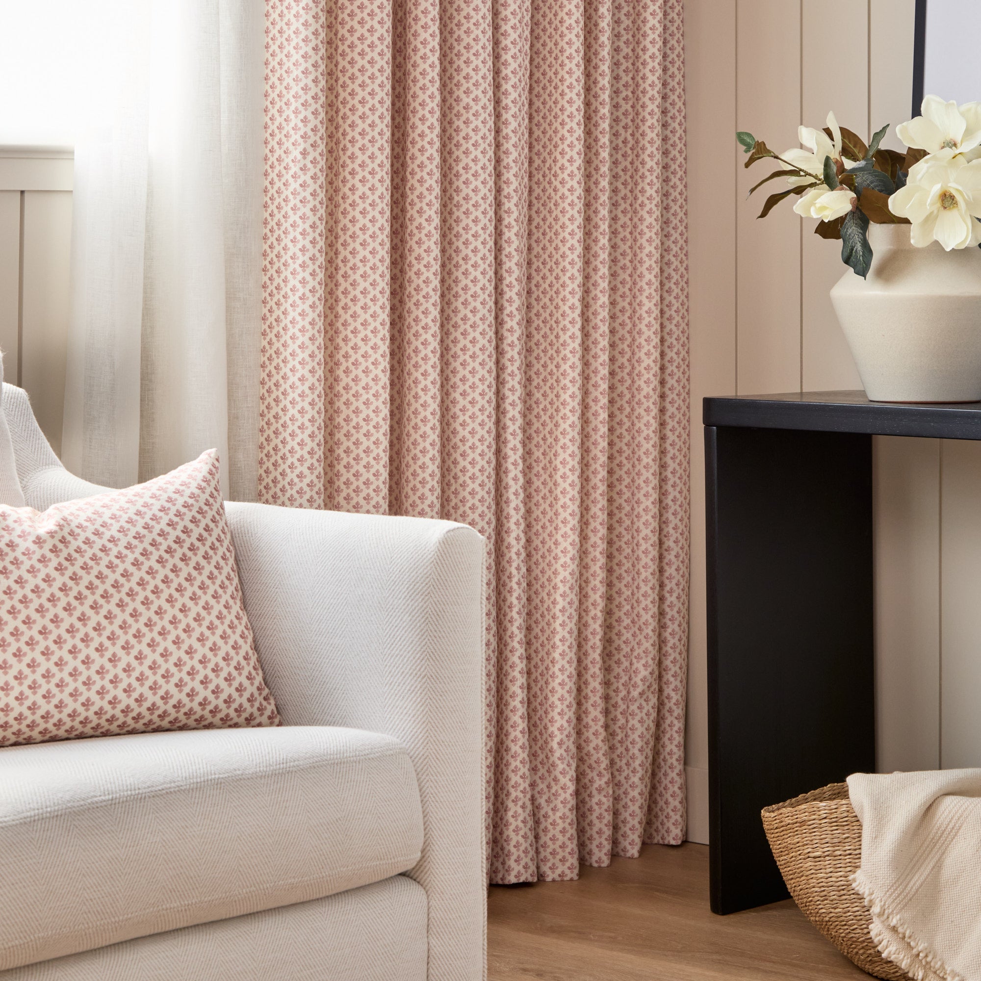 Lyra Fabric, Berry by Tonic Living — shown as floral block print drapery behind a chair styled with the Lyra 14x20 Lumbar Pillow, Berry.