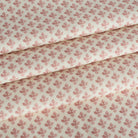 Lyra Berry roman shade fabric by Tonic Living — lightweight linen-blend fabric with a white and dark rose floral block print.