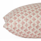 Close-up side view of Lyra Berry lumbar cushion by Tonic Living — floral block print in white and dark rose tones.