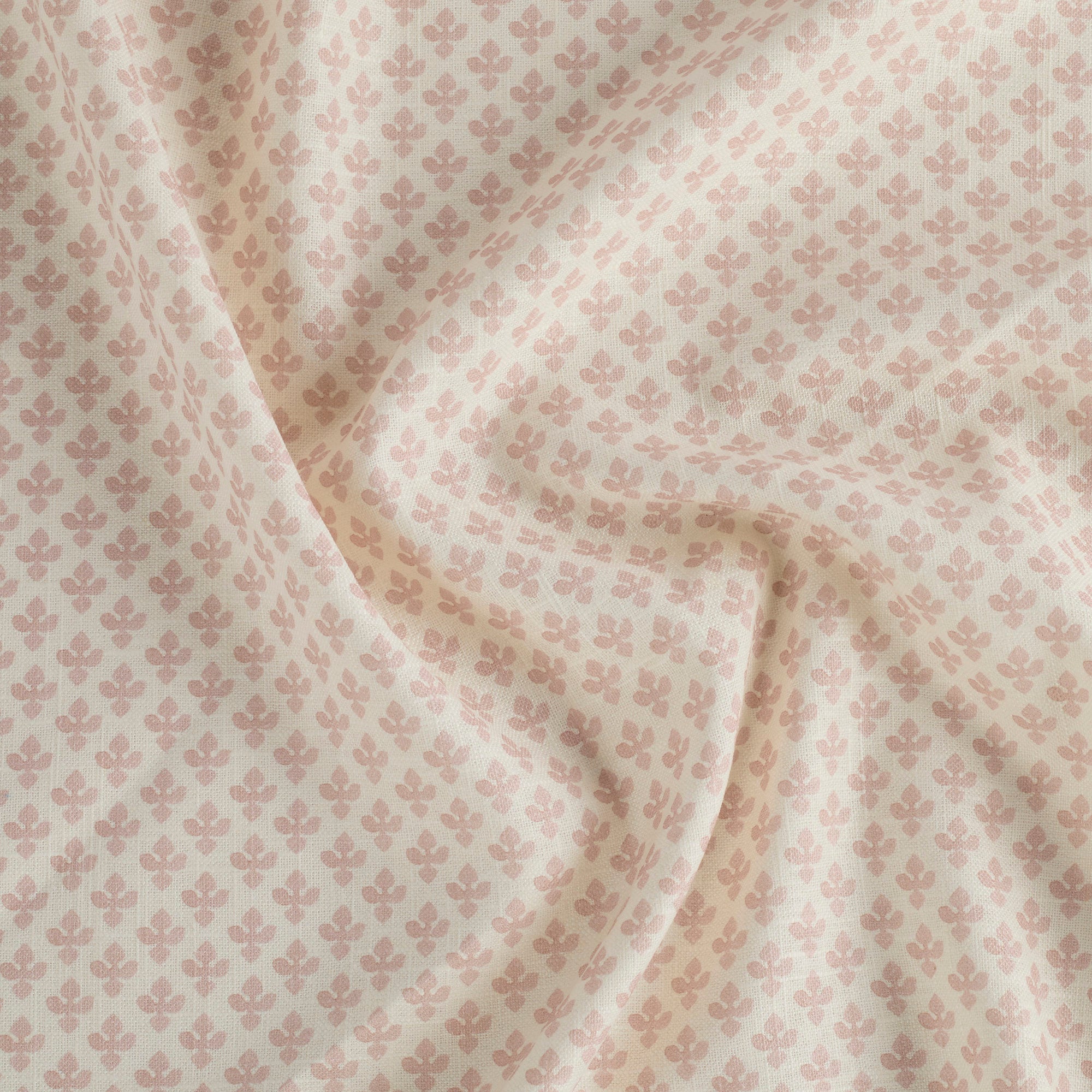 Lyra Blush high-quality drapery fabric by Tonic Living — white and light pink floral block print on soft linen-blend material.
