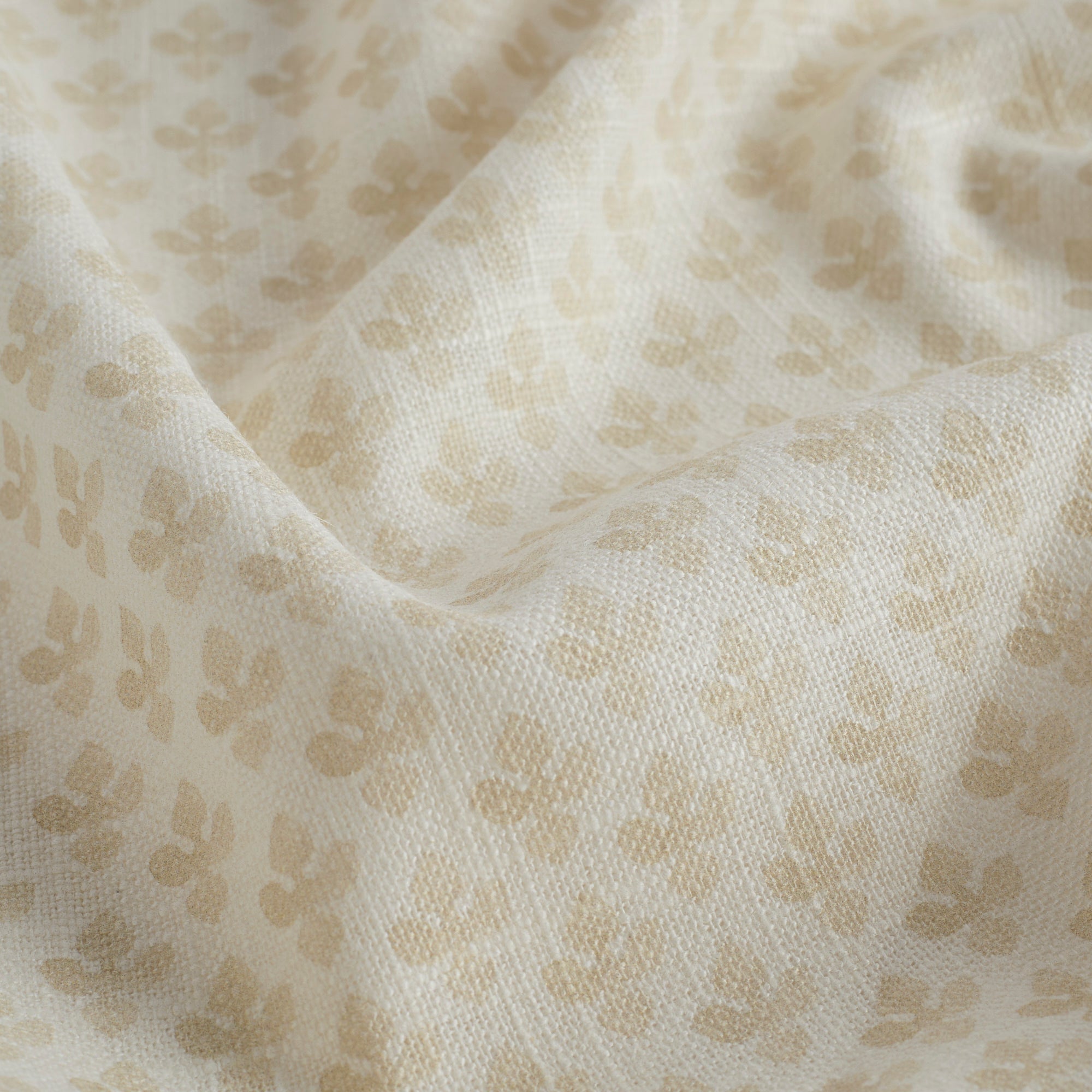 Close-up of Lyra Fabric, Parchment by Tonic Living — lightweight linen-blend fabric with a delicate neutral floral block print.