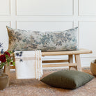 Styled Tonic Living pillows: Manor Tapestry Sage extra long bolster pillow with Bedford Moss cushion on a bench.
