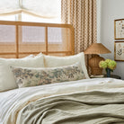 Tonic Living's Manor Tapestry 16x42 bolster pillow in sage green styled on a bed.