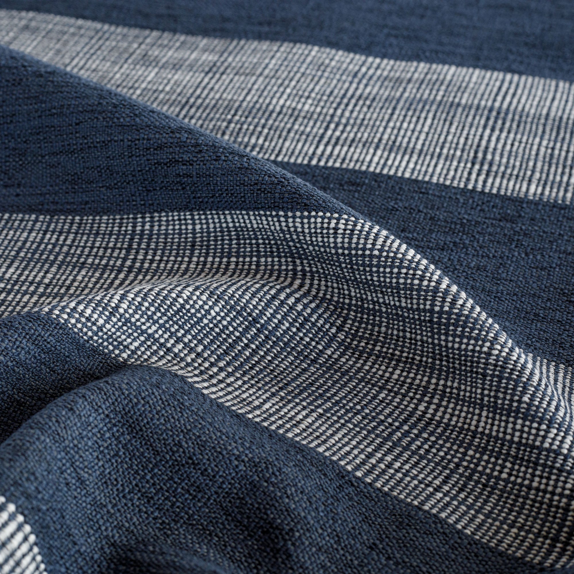 a deep navy blue and white textured stripe upholstery fabric