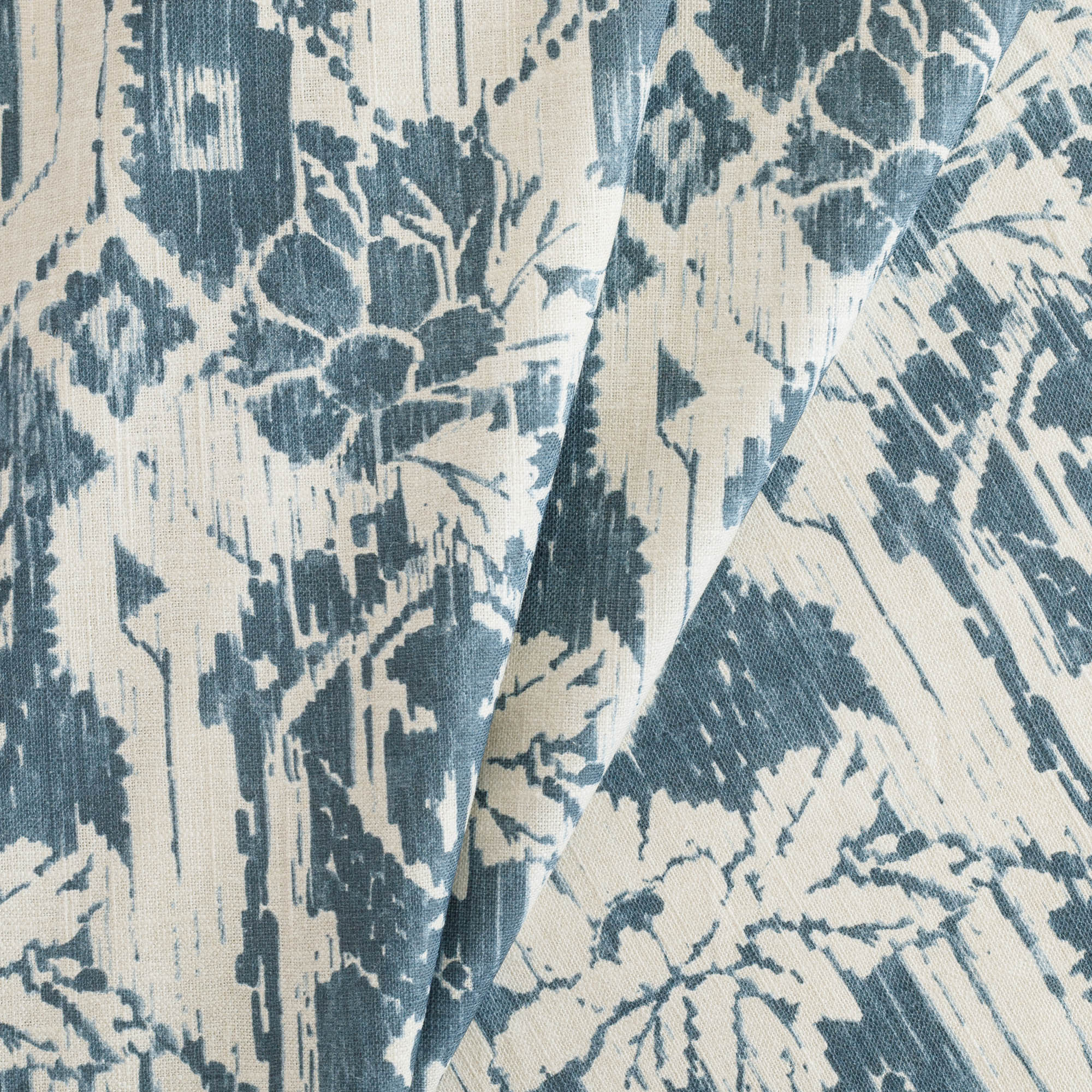 a cream and blue botanical ikat print home decor fabric