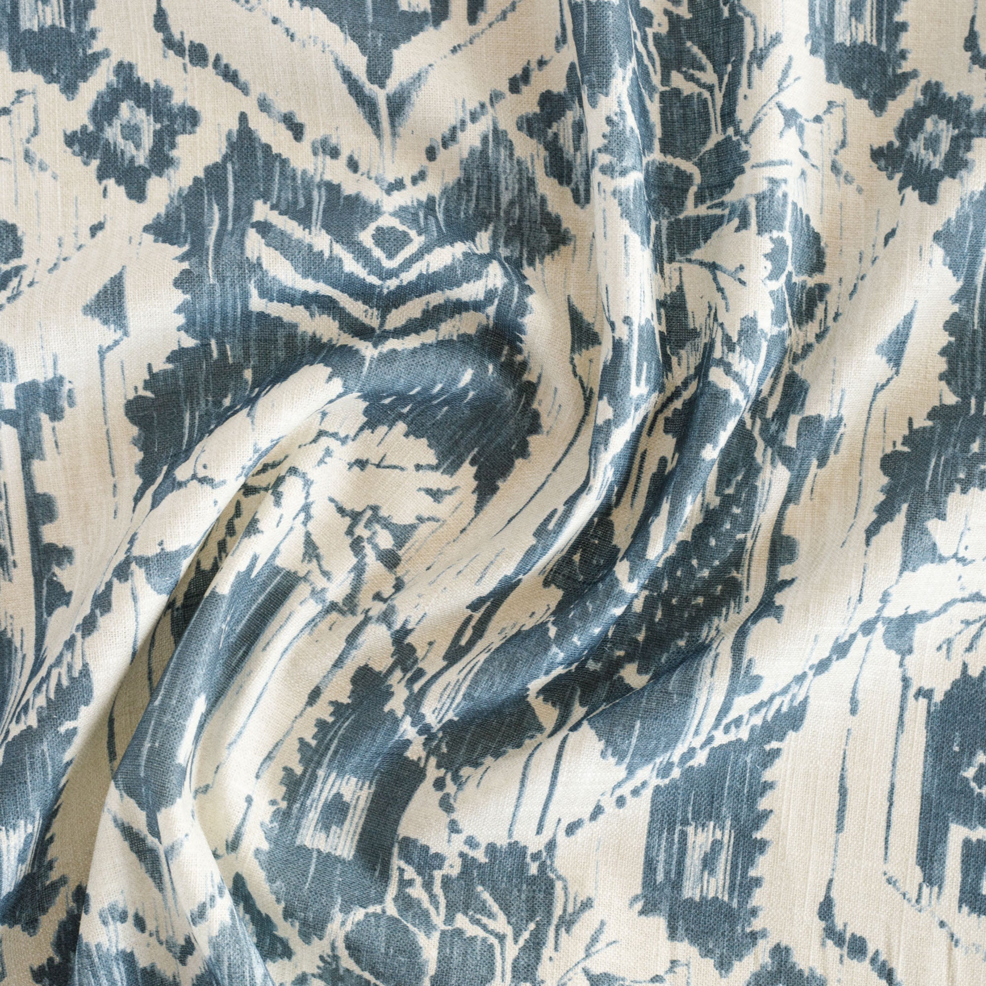 a cream and blue botanical ikat print fabric