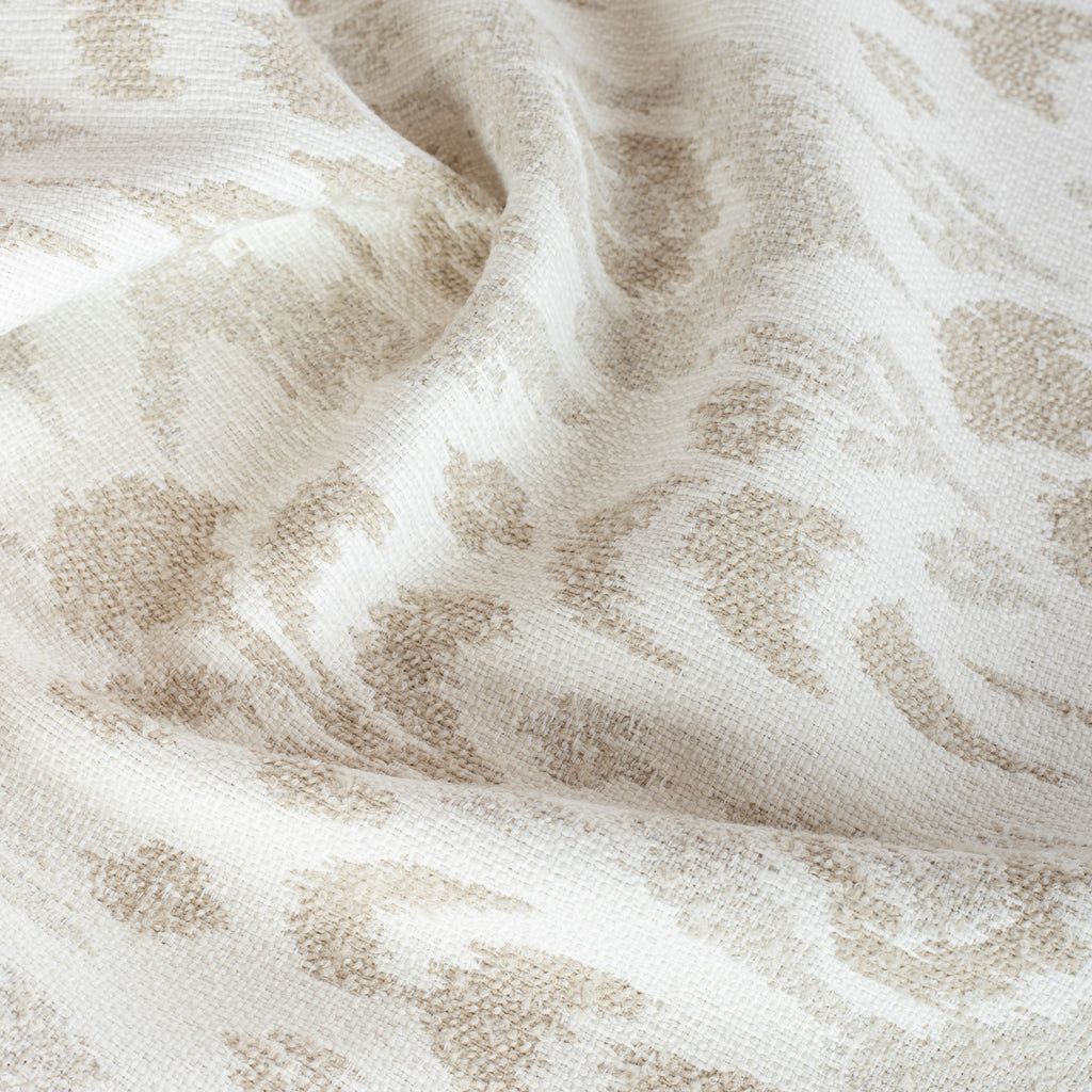 a cream, white and taupe ikat patterned, chenille textured upholstery fabric