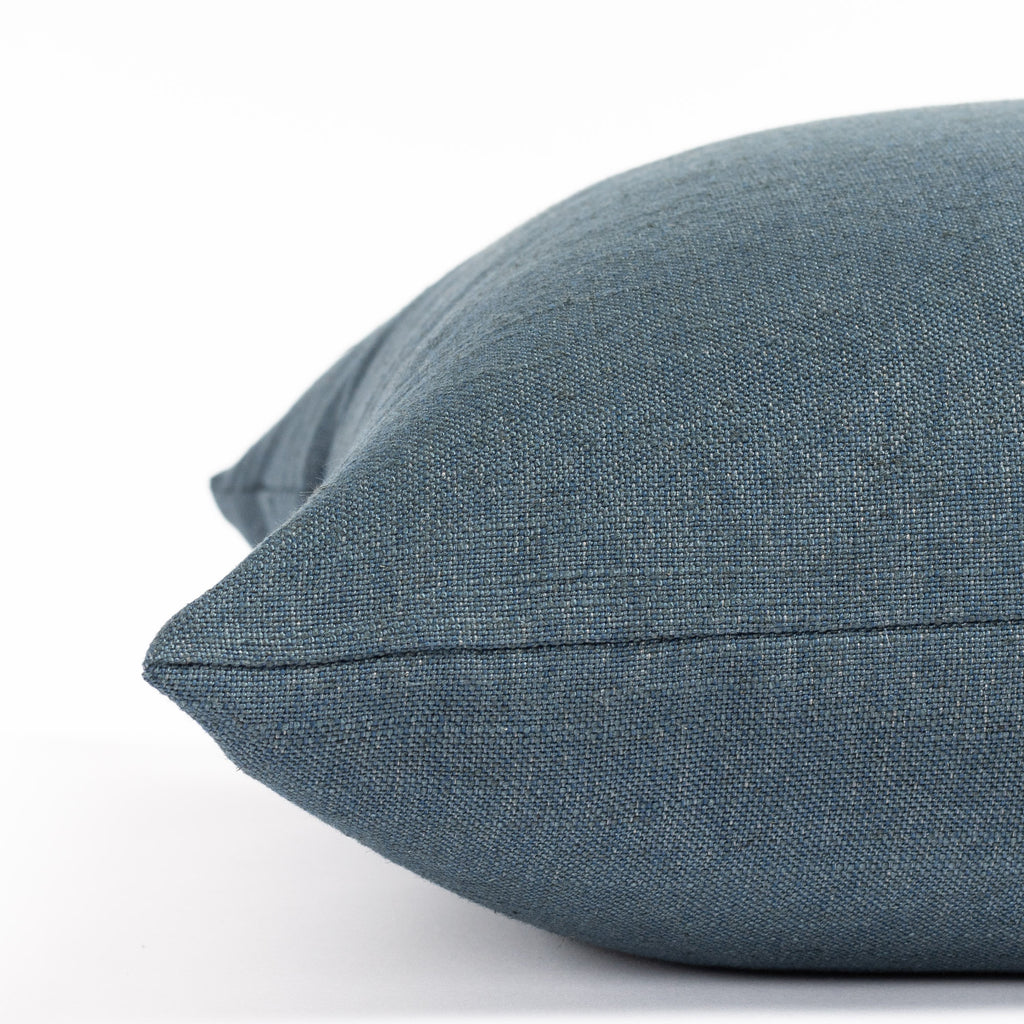 an indigo solid blue throw pillow: close up side view 