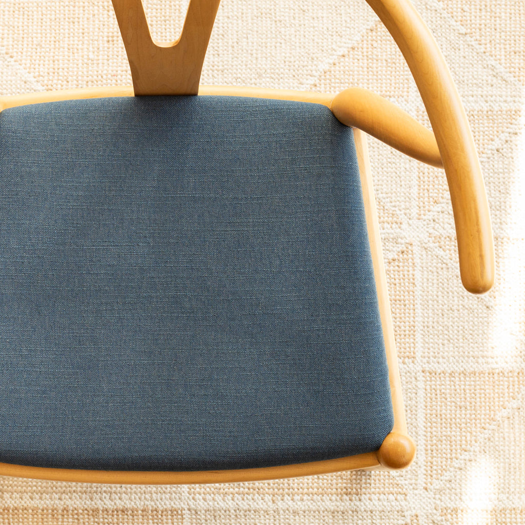 a solid blue linen blend upholstered fabric chair seat