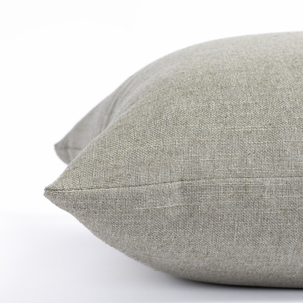 a solid dusty grey green throw pillow : close up side view