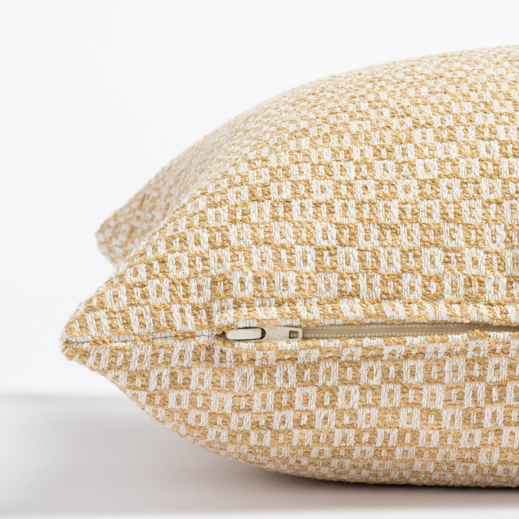 a yellow and cream small geometric check patterned throw pillow : close up zipper view