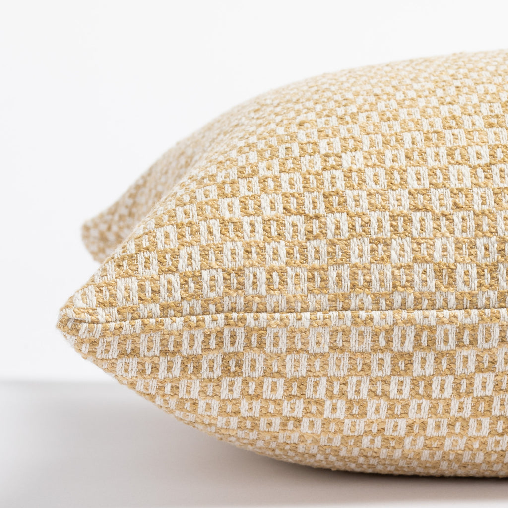 a yellow and cream small geometric check patterned throw pillow : close up side view