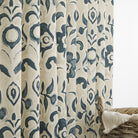 Tonic Living Paloma Ink floral drapery fabric shown as curtains featuring a painterly navy blue botanical pattern on oatmeal beige.