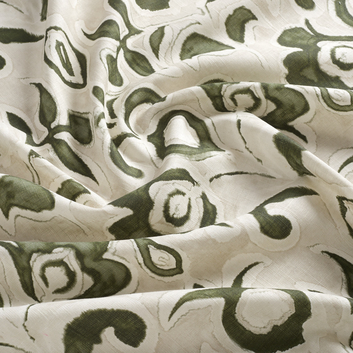 Tonic Living Paloma Olive drapery fabric featuring bold olive green blooms and scrolling leaves on a neutral oatmeal background.