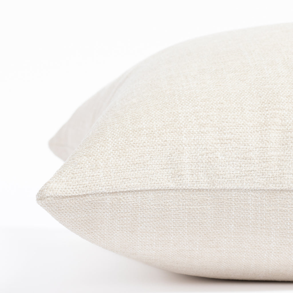 a cream indoor outdoor throw pillow: close up side view