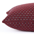 Detailed side view of Pembrook 14x20 burgundy red lumbar cushion with woven diamond motif, Tonic Living.