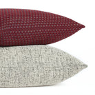 Pembrook 20x20 burgundy red pillow stacked with Atlas Salt & Pepper black and off-white cushion, Tonic Living.
