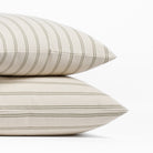 Stack of two Tonic Living Rexton Stripe Moss 24x24 decorative bed pillows in olive green and oatmeal stripes.