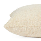 Side view of Tonic Living Rupert Parchment decorative cushion highlighting its plush cream bouclé texture.