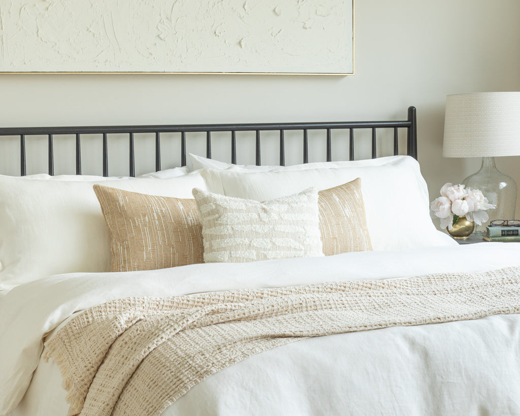 Soft Gold and Cream Bed Pillow Pairing : a low-profile combination of a golden-wheat and cream bed bolster pillows and a cream textured lumbar pillow