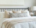 Burlap and Pewter Bed Pillow Pairing: a combination of burlap and charcoal striped throw pillows with a vintage grey floral bolster