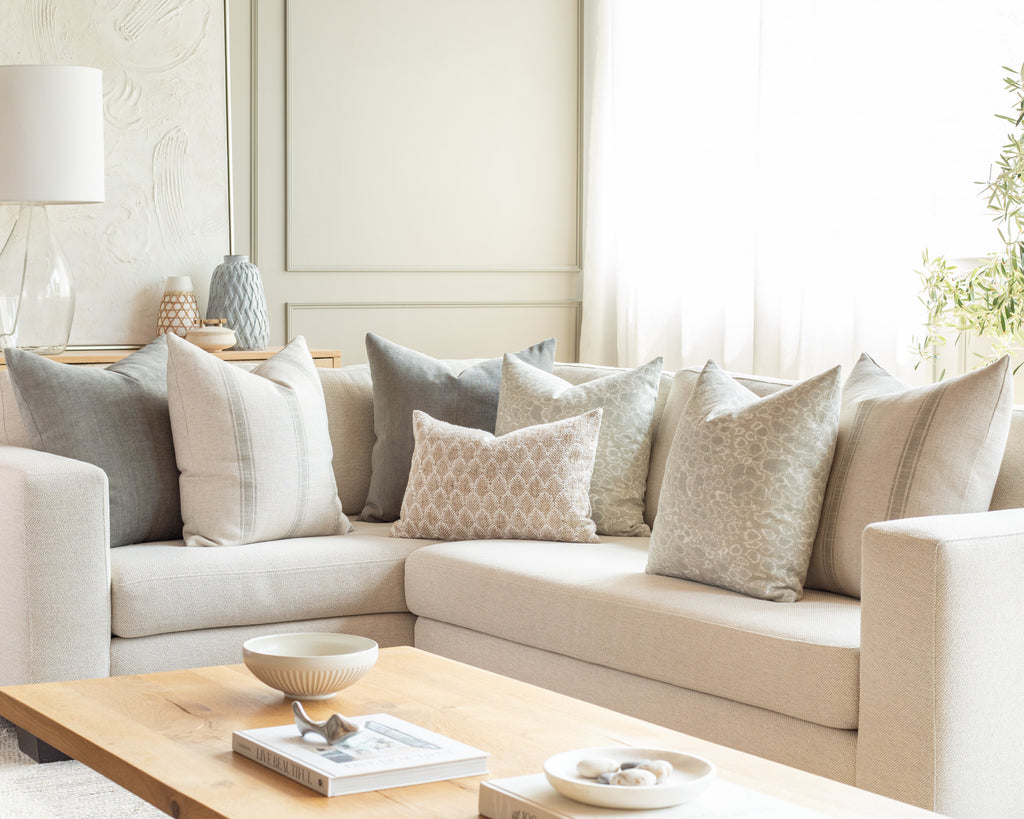 Watery blue and oatmeal sectional pillow pairing : a combination of crystalline blue and off-white throw pillows 