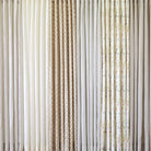 Tonic Living shower curtain collection featuring neutral linen curtains in ivory, black, stripe, and soft botanical patterns.